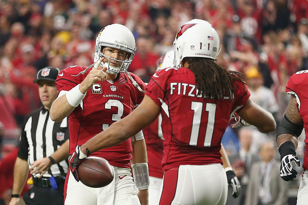 GLENDALE, AZ - DECEMBER 27: Wide receiver Larry Fitzgerald #11 and quarterback Carson Palmer #3 of the Arizona Cardinals celebrate after Fitzgerald scored a 3 yard touchdown in the second quarter of the NFL game against the Green Bay Packers at the University of Phoenix Stadium on December 27, 2015 in Glendale, Arizona.