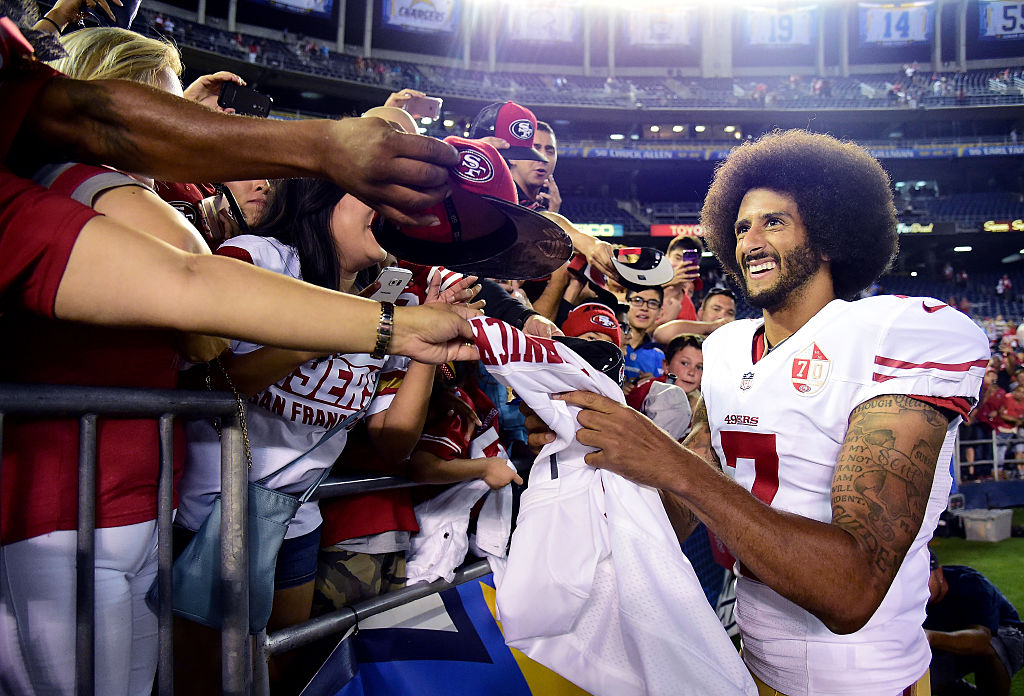 SAN DIEGO, CA - SEPTEMBER 01: Colin Kaepernick #7 of the San Francisco 49ers signs autographs for fans after a 31-21 win over the San Diego Chargers during a preseason game at Qualcomm Stadium on September 1, 2016 in San Diego, California.