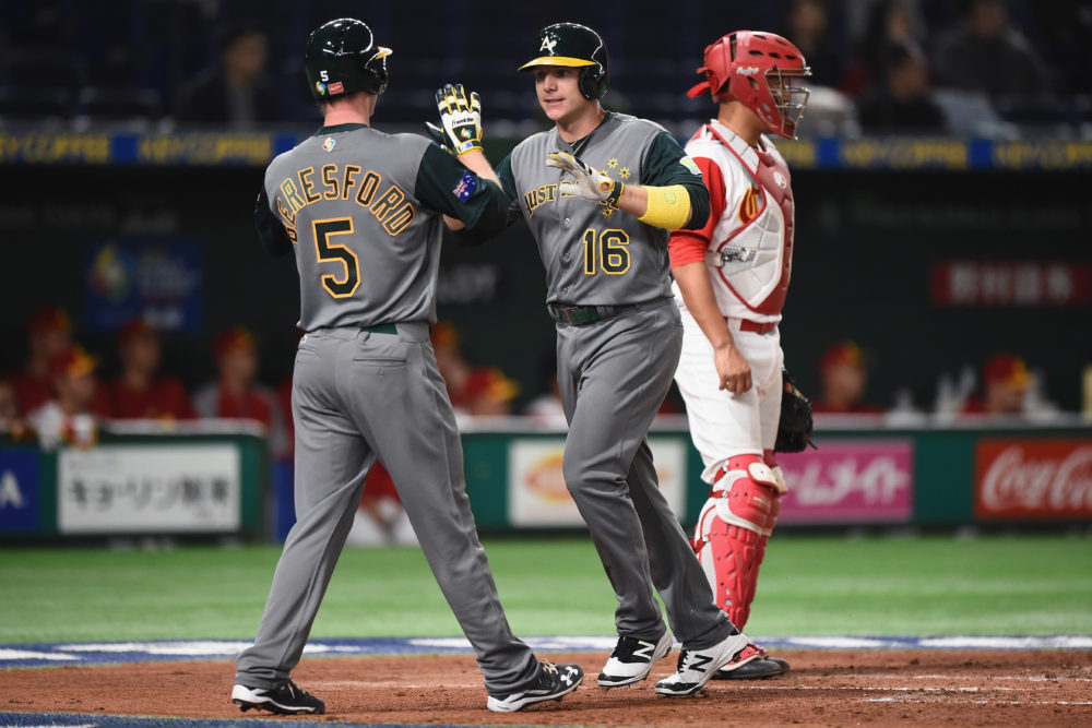TOKYO, JAPAN - MARCH 09: Infielder Luke Hughes #16 of Australia celebrates with his team mate James Beresford #5 after hitting a two run homer in the top of the third inning to make it 2-0 during the World Baseball Classic Pool B Game Four between Australia and China at the Tokyo Dome on March 9, 2017 in Tokyo, Japan.