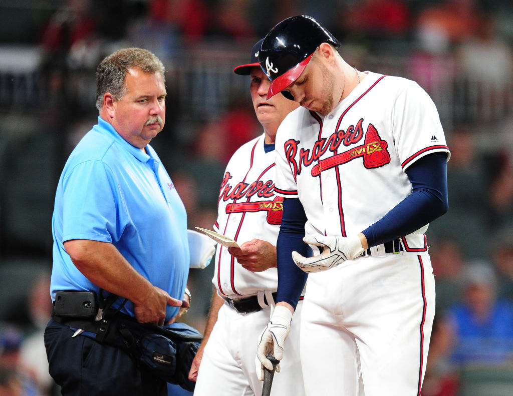 ATLANTA, GA - MAY 17: Freddie Freeman #5 of the Atlanta Braves is removed by Manager Brian Snitker #43 as trainer Jim Lovell watches after being hit by a fifth inning pitch against the Toronto Blue Jays at SunTrust Park on May 17, 2017 in Atlanta, Georgia