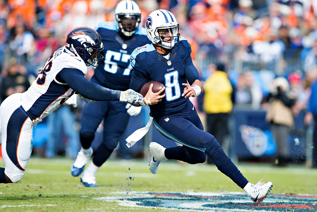 NASHVILLE, TN - DECEMBER 11: Marcus Mariota #8 of the Tennessee Titans slides to avoid the tackle of Von Miller #58 of the Denver Broncos at Nissan Stadium on December 11, 2016 in Nashville, Tennessee. 