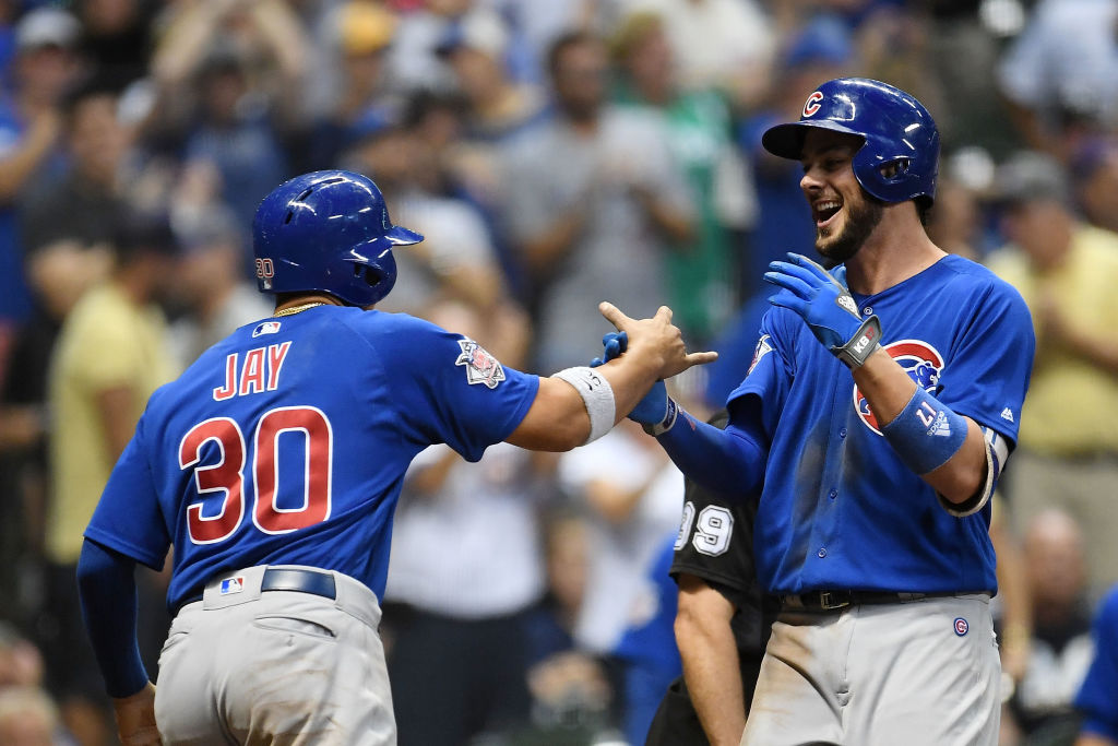 MILWAUKEE, WI - SEPTEMBER 21: Kris Bryant #17 of the Chicago Cubs is congratulated by Jon Jay #30 following a two run home run against the Milwaukee Brewers during the tenth inning of a game at Miller Park on September 21, 2017 in Milwaukee, Wisconsin. 