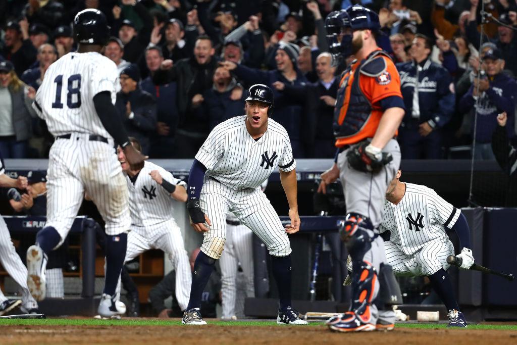NEW YORK, NY - OCTOBER 17: Aaron Judge #99 of the New York Yankees celebrates as he and teammate Didi Gregorius #18 score on a two-run go-ahead double by Gary Sanchez #24 during the eighth inning against the Houston Astros in Game Four of the American League Championship Series at Yankee Stadium on October 17, 2017 in the Bronx borough of New York City.