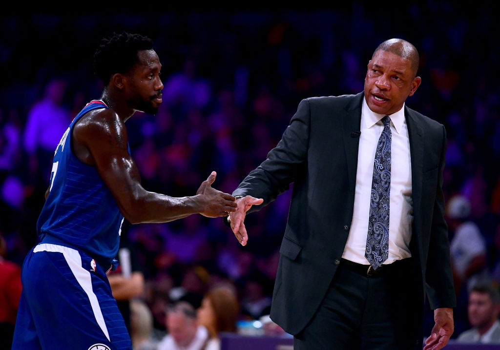 Head coach Doc Rivers of the LA Clippers touches hands with Patrick Beverley #21 in a 108-92 Clipper win during the Los Angeles Lakers home opener at Staples Center on October 19, 2017 in Los Angeles, California.