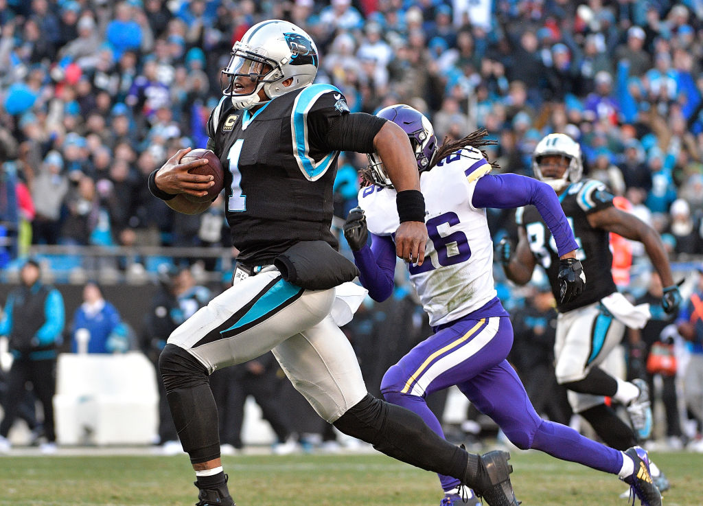 Cam Newton #1 of the Carolina Panthers sprints past Trae Waynes #26 of the Minnesota Vikings for a long gain to set up the game-winning touchdown during their game at Bank of America Stadium on December 10, 2017 in Charlotte, North Carolina.