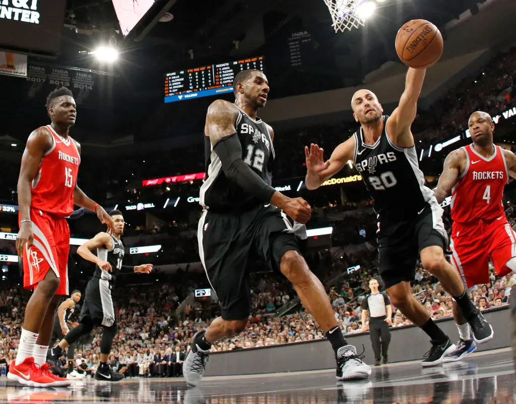 SAN ANTONIO,TX - APRIL 1 : Manu Ginobili #20 of the San Antonio Spurs reaches to save a ball from going out of bounds against the Houston Rockets at AT&T Center on April 1 , 2018 in San Antonio, Texas