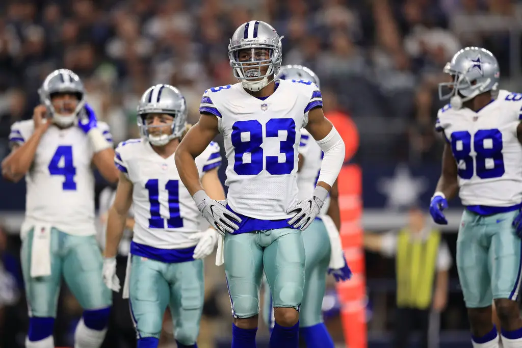 ARLINGTON, TX - DECEMBER 24: Wide receivers Cole Beasley #11, Terrance Williams #83, and Dez Bryant #88 of the Dallas Cowboys walk to the sidelines in the first quarter of a football game against the Seattle Seahawks at AT&T Stadium on December 24, 2017 in Arlington, Texas.