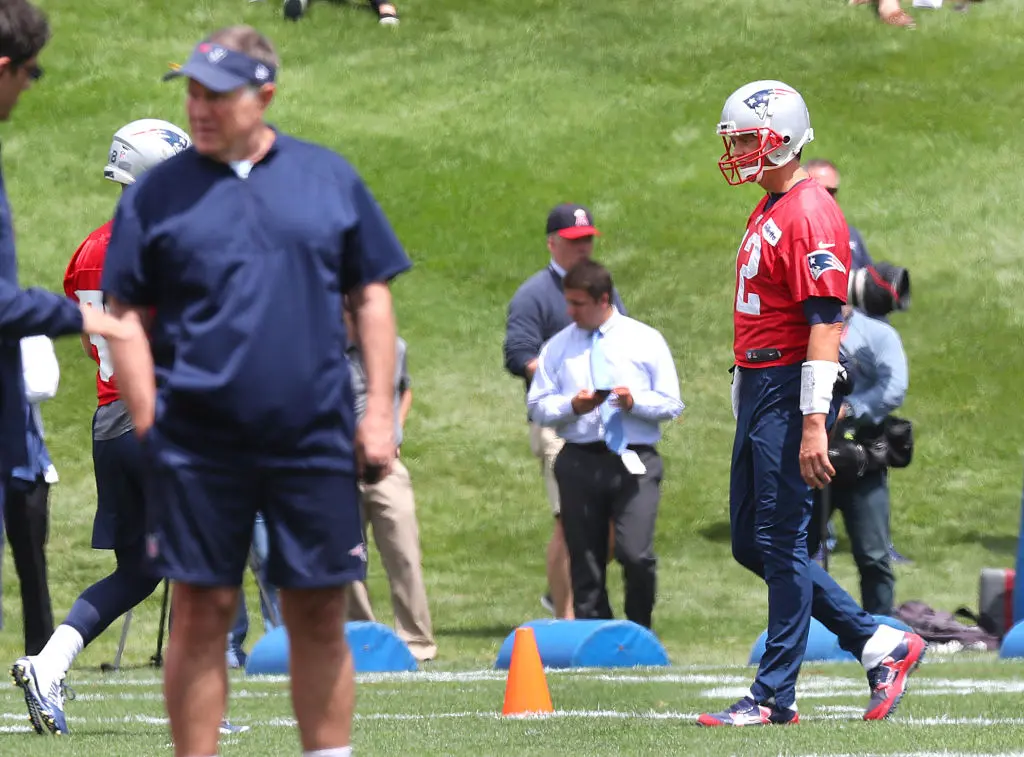 FOXBOROUGH, MA - JUNE 5: New England Patriots quarterback Tom Brady, right, walks on the field during a passing drill at Patriots minicamp as head coach Bill Belichick stands at foreground left at the Gillette Stadium practice facility in Foxborough, MA on June 5, 2018.