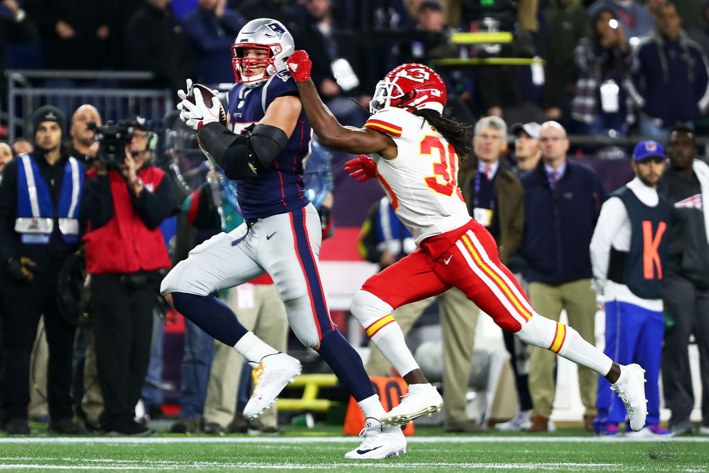 FOXBOROUGH, MA - OCTOBER 14: Rob Gronkowski #87 of the New England Patriots makes a catch while under pressure from Josh Shaw #30 of the Kansas City Chiefs in the fourth quarter of a game at Gillette Stadium on October 14, 2018 in Foxborough, Massachusetts