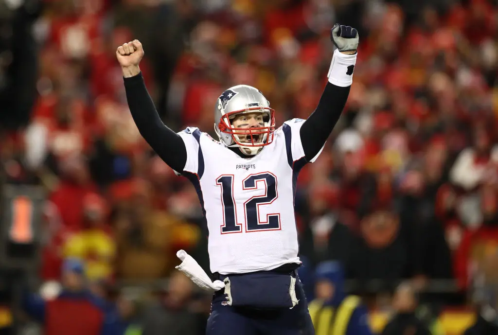 KANSAS CITY, MISSOURI - JANUARY 20: Tom Brady #12 of the New England Patriots celebrates after defeating the Kansas City Chiefs in overtime during the AFC Championship Game at Arrowhead Stadium on January 20, 2019 in Kansas City, Missouri. The Patriots defeated the Chiefs 37-31