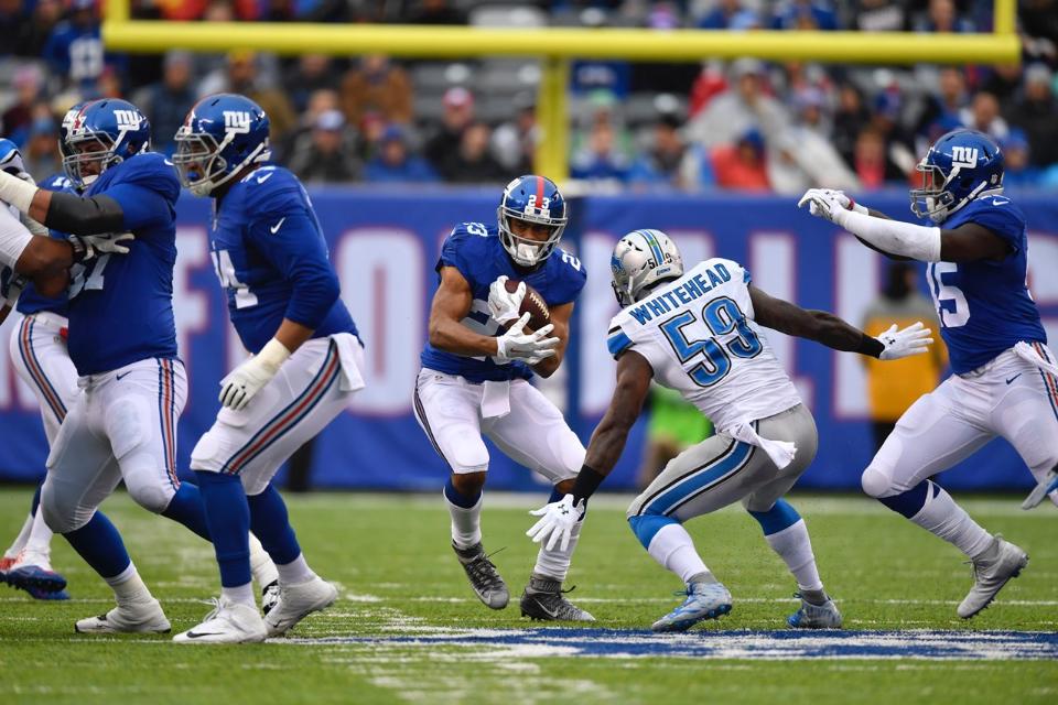 Rashad Jennings em uma jogada terrestre na vitória dos Giants sobre os Lions na Semana 15 da NFL