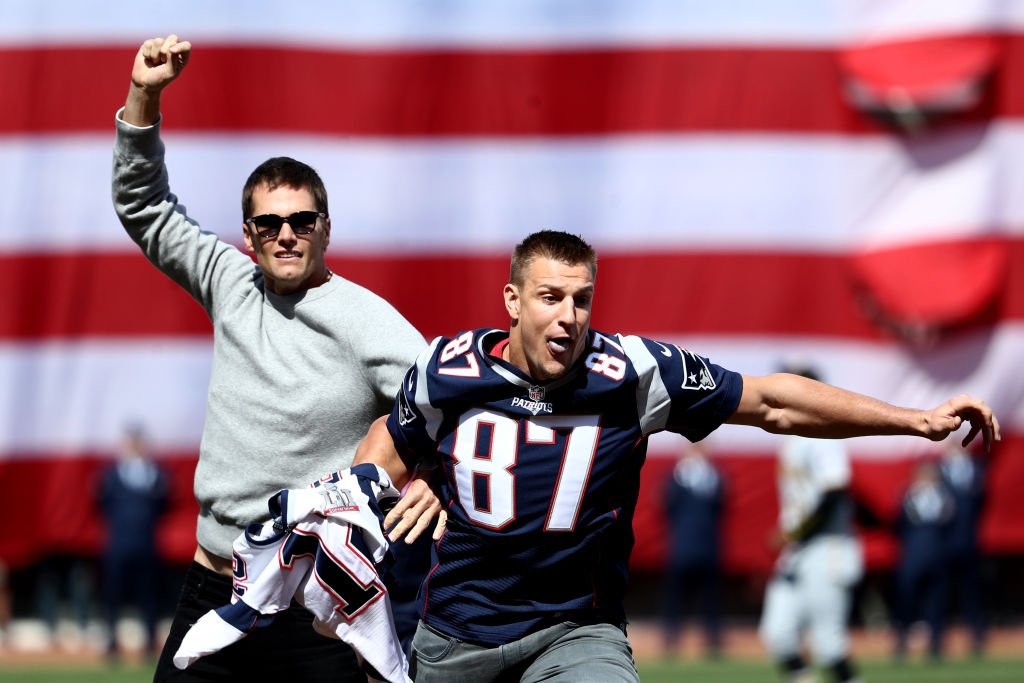 BOSTON, MA - APRIL 3: Rob Gronkowski of the New England Patriots steals Tom Brady's jersey before the opening day game between the Boston Red Sox and the Pittsburgh Pirates at Fenway Park on April 3, 2017 in Boston, Massachusetts.