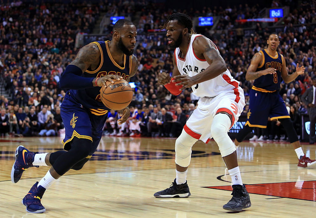 Lebron James #23 of the Cleveland Cavaliers dribbles the ball as DeMarre Carroll #5 of the Toronto Raptors defends during the first half of an NBA game at Air Canada Centre on December 5, 2016 in Toronto, Canada.