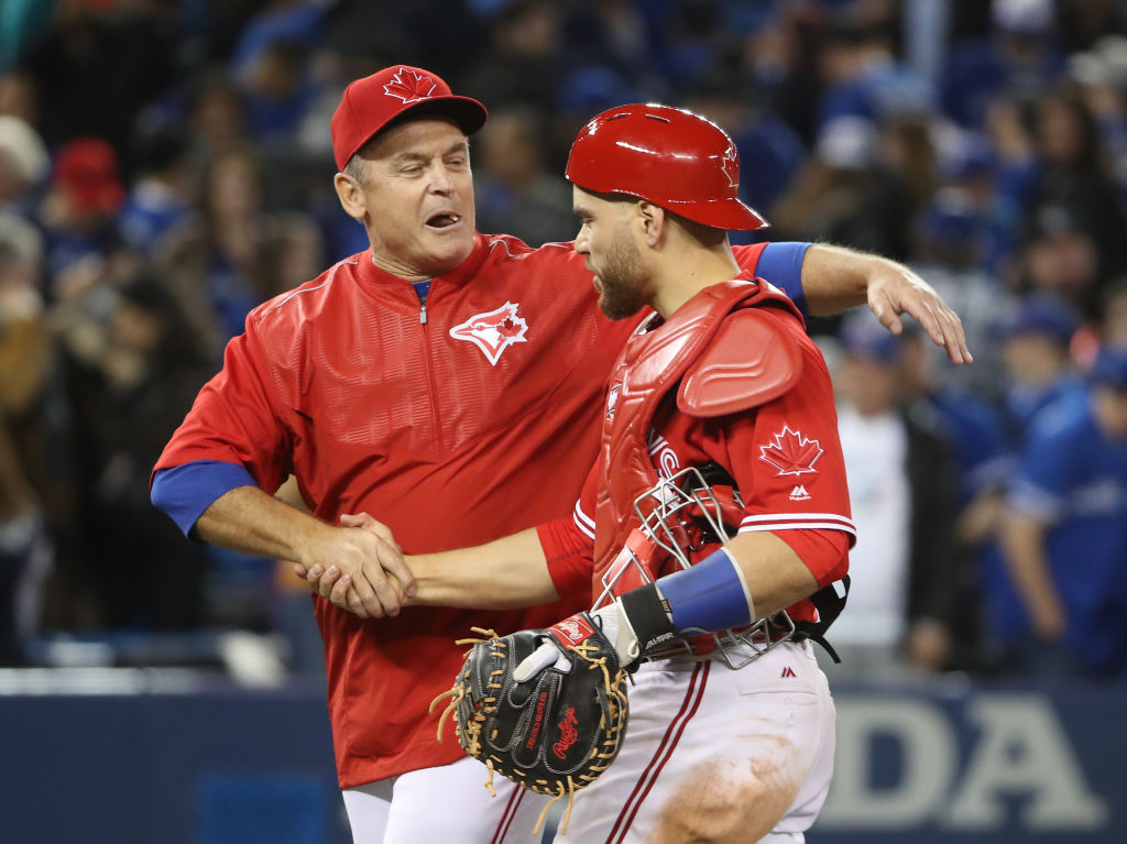 TORONTO, ON - APRIL 30: Russell Martin #55 of the Toronto Blue Jays is congratulated on their victory by manager John Gibbons #5 during MLB game action against the Tampa Bay Rays at Rogers Centre on April 30, 2017 in Toronto, Canada