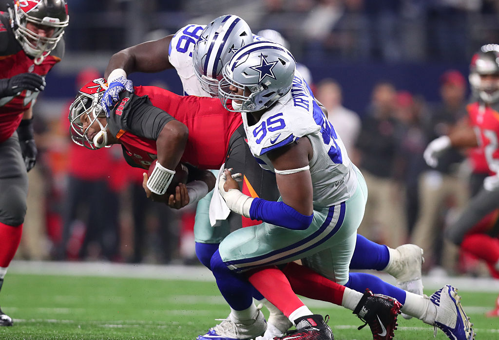 ARLINGTON, TX - DECEMBER 18: David Irving #95 and Maliek Collins #96 of the Dallas Cowboys sack Jameis Winston #3 of the Tampa Bay Buccaneers during the fourth quarter at AT&T Stadium on December 18, 2016 in Arlington, Texas.