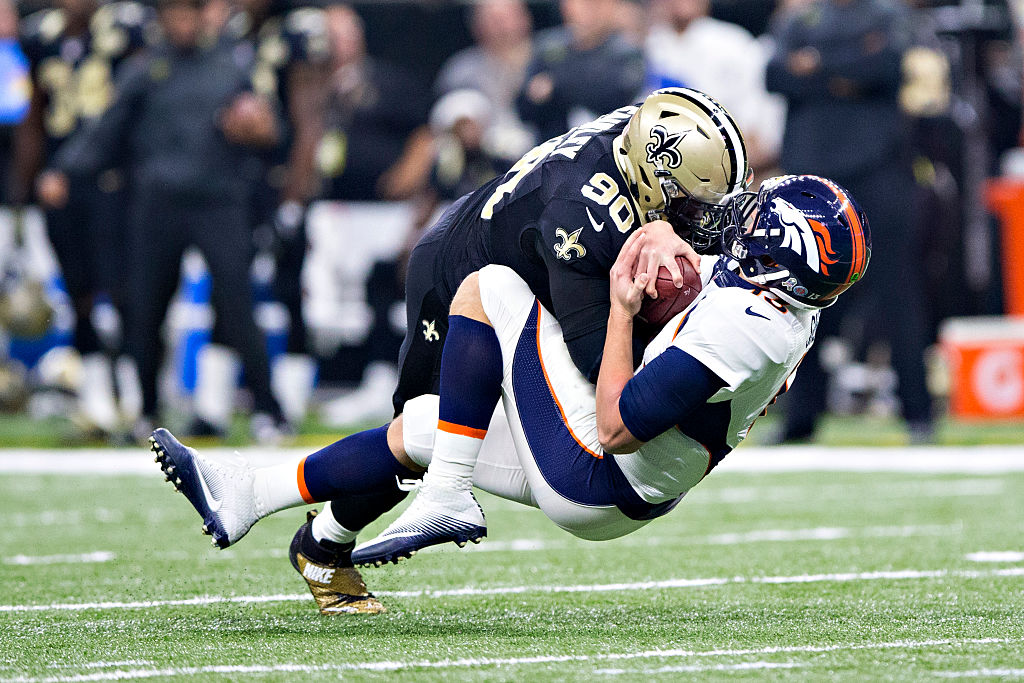 NEW ORLEANS, LA - NOVEMBER 13: Trevor Siemian #13 of the Denver Broncos is sacked by Nick Fairley #90 of the New Orleans Saints at Mercedes-Benz Superdome on November 13, 2016 in New Orleans, Louisiana.