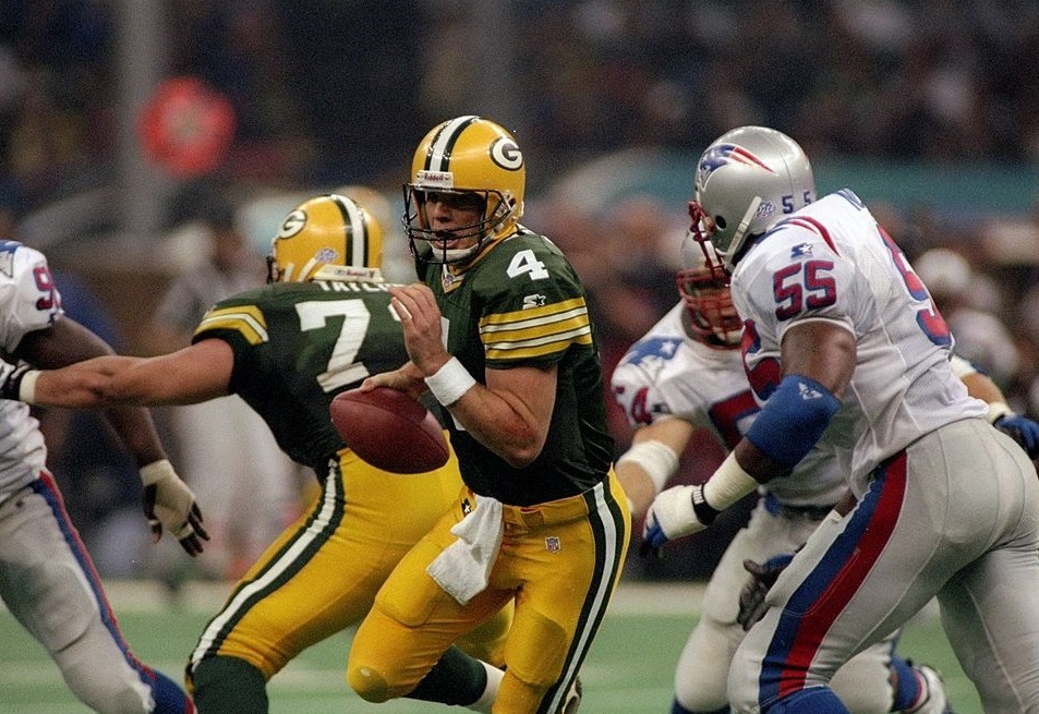 26 Jan 1997: Quarterback Brett Favre of the Green Bay Packers attempts to avoid New England Patriots defensive lineman Willie McGinest during Super Bowl XXXI at the Superdome in New Orleans, Louisiana. The Packers won the game, 35-21.