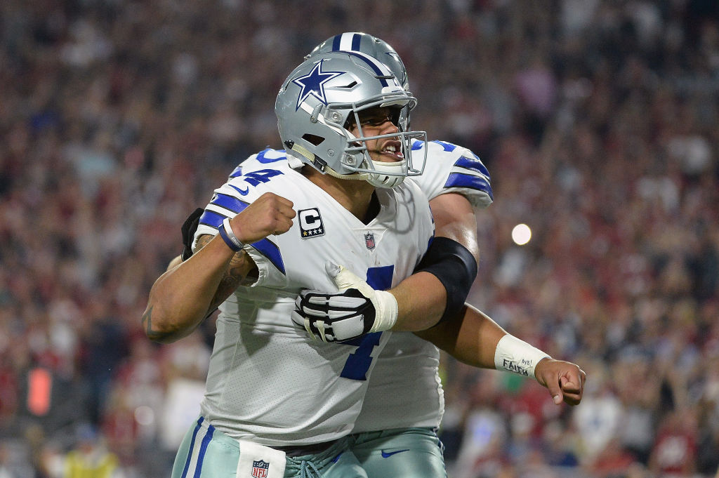 GLENDALE, AZ - SEPTEMBER 25: Offensive guard Zack Martin #70 reacts with quarterback Dak Prescott #4 of the Dallas Cowboys after scoring on a ten yard run during the second quarter of the NFL game against the Arizona Cardinals at the University of Phoenix Stadium on September 25, 2017 in Glendale, Arizona. 