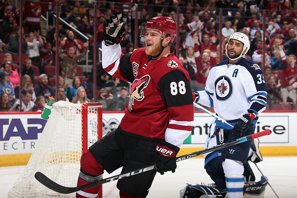 GLENDALE, AZ - JANUARY 13:  Jamie McGinn #88 of the Arizona Coyotes celebrates after scoring a goal against Dustin Byfuglien #33 and the Winnipeg Jets during the first period of the NHL game at Gila River Arena on January 13, 2017 in Glendale, Arizona. 