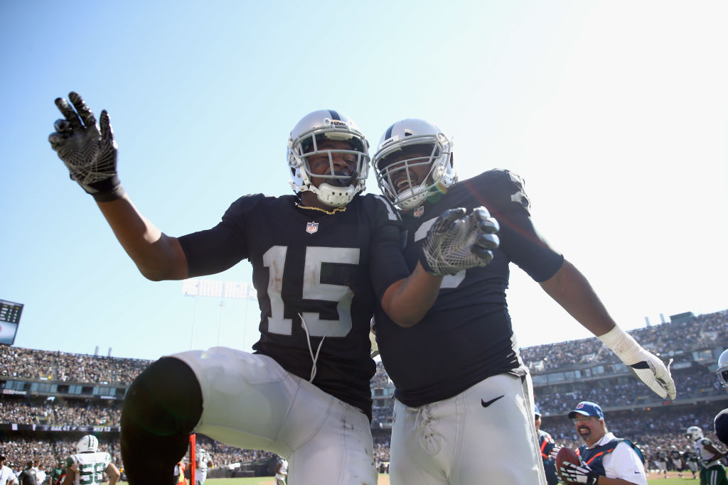 OAKLAND, CA - SEPTEMBER 17: Michael Crabtree #15 of the Oakland Raiders celebrates with Marshall Newhouse #73 and he Crabtree scored a touchdown against the New York Jets at Oakland-Alameda County Coliseum on September 17, 2017 in Oakland, California.