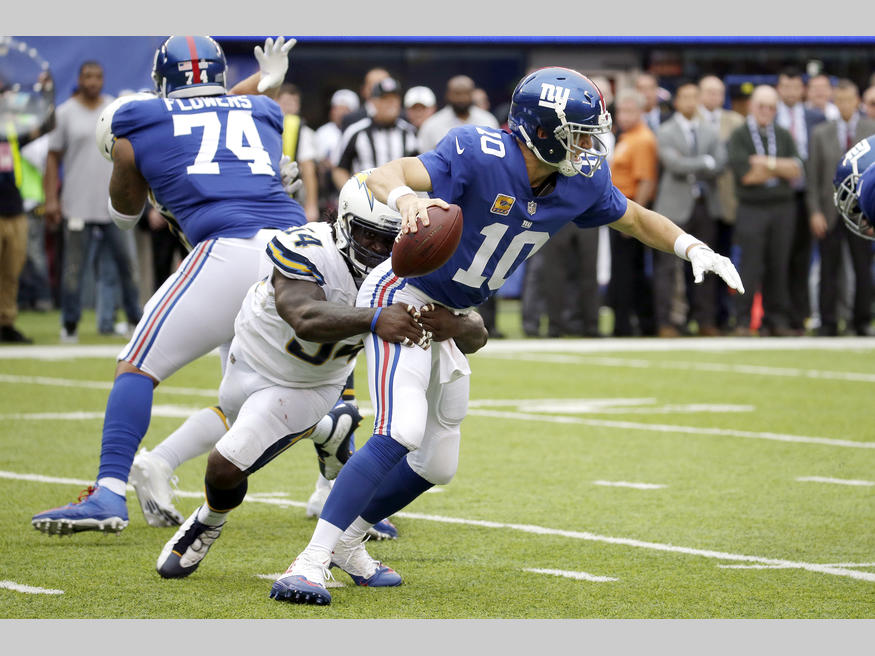 Los Angeles Chargers outside linebacker Melvin Ingram (54) grabs at New York Giants quarterback Eli Manning (10) during the second half of an NFL football game, Sunday, Oct. 8, 2017, in East Rutherford, N.J. Ingram forced a fumble and recovered it on the play. (AP Photo/Seth Wenig)