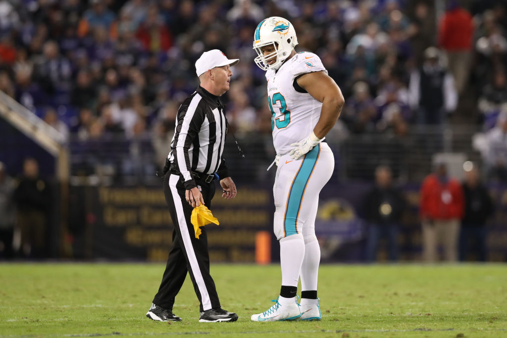 BALTIMORE, MD - OCTOBER 26: Defensive Tackle Ndamukong Suh #93 of the Miami Dolphins talks with referee John Parry after a play in the third quarter against the Baltimore Ravens at M&T Bank Stadium on October 26, 2017 in Baltimore, Maryland.