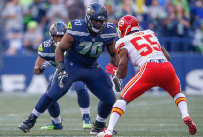 SEATTLE, WA - AUGUST 25: Guard Rees Odhiambo #70 of the Seattle Seahawks pass blocks against linebacker Dee Ford #55 of the Kansas City Chiefs at CenturyLink Field on August 25, 2017 in Seattle, Washington.