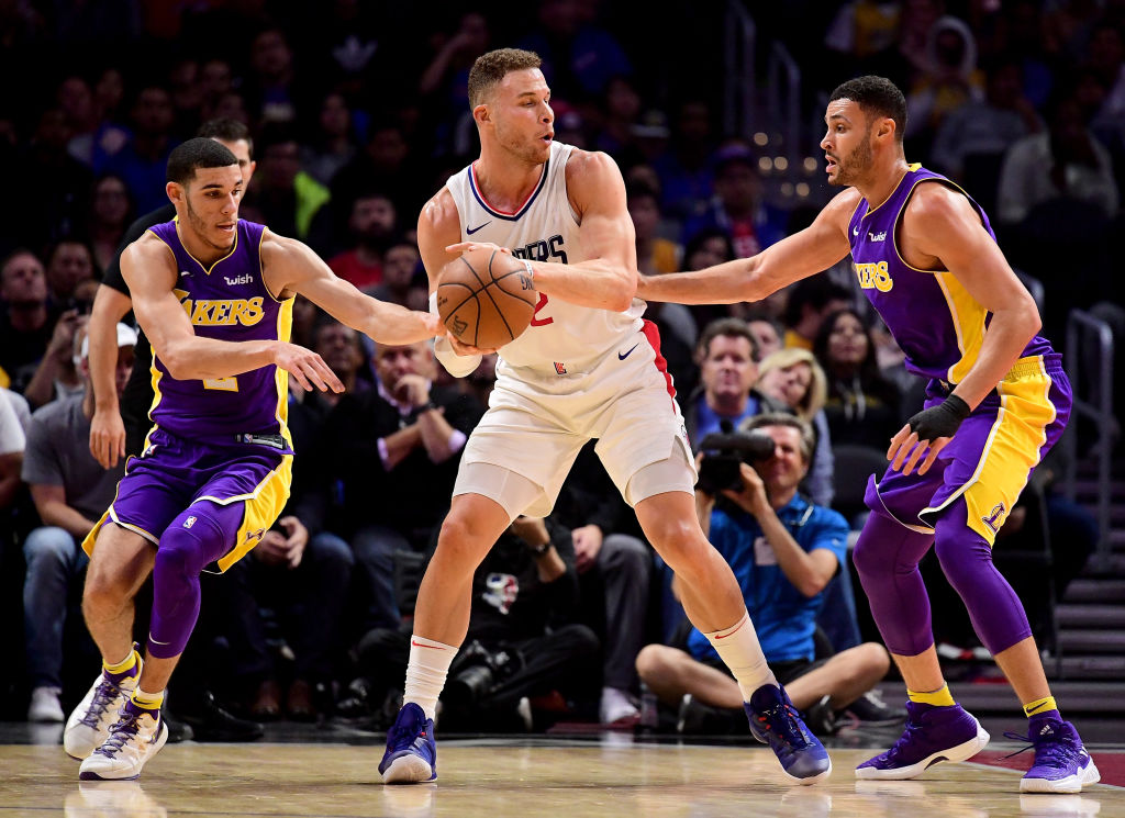 LOS ANGELES, CA - NOVEMBER 27: Lonzo Ball #2 of the Los Angeles Lakers fouls Blake Griffin #32 of the LA Clippers attempting a steal in front of Larry Nance Jr. #7 during the first half at Staples Center on November 27, 2017 in Los Angeles, California.