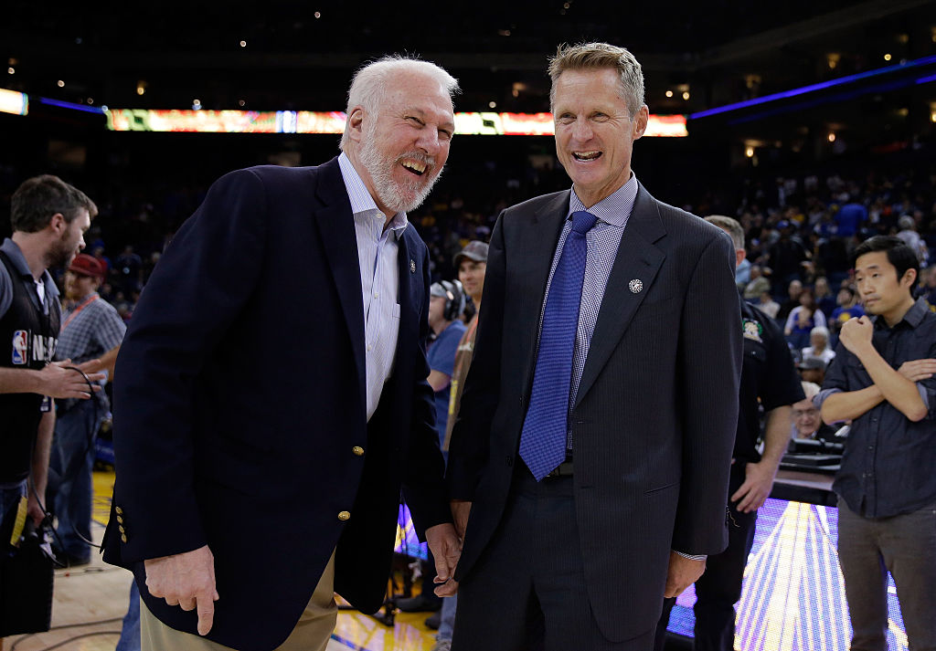 OAKLAND, CA - NOVEMBER 11: Head coach Gregg Popovich (left) of the San Antonio Spurs talks with head coach Steve Kerr of the Golden State Warriors before their game at ORACLE Arena on November 11, 2014 in Oakland, California