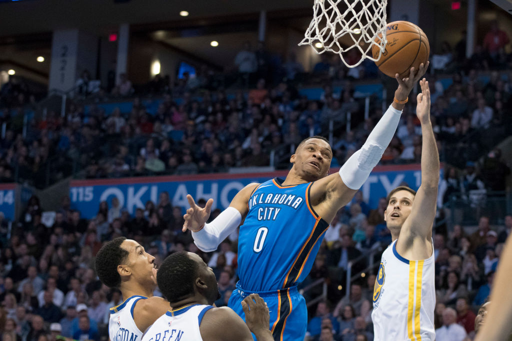 OKLAHOMA CITY, OK - NOVEMBER 22: Russell Westbrook #0 of the Oklahoma City Thunder shoots over Omri Casspi #18 of the Golden State Warriors during the first half of a NBA game at the Chesapeake Energy Arena on November 22, 2017 in Oklahoma City, Oklahoma
