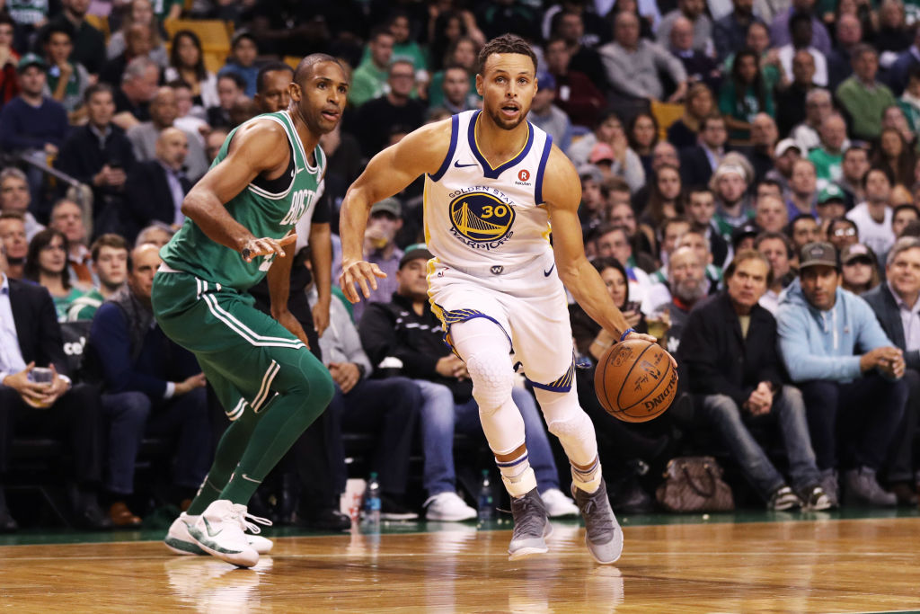 BOSTON, MA - NOVEMBER 16: Stephen Curry #30 of the Golden State Warriors drives past Al Horford #42 of the Boston Celtics during the first quarter at TD Garden on November 16, 2017 in Boston, Massachusetts.