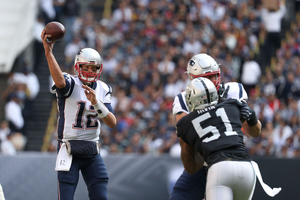 MEXICO CITY, MEXICO - NOVEMBER 19: Tom Brady #12 of the New England Patriots throws a pass against the Oakland Raiders during the first half at Estadio Azteca on November 19, 2017 in Mexico City, Mexico.