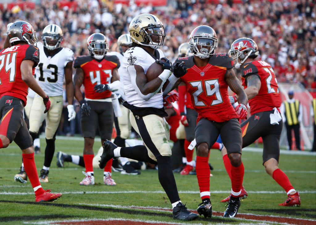 TAMPA, FL - DECEMBER 31: Running back Alvin Kamara #41 of the New Orleans Saints rushes 7-yards for a touchdown during the first quarter of an NFL football game against the Tampa Bay Buccaneers on December 31, 2017 at Raymond James Stadium in Tampa, Florida.