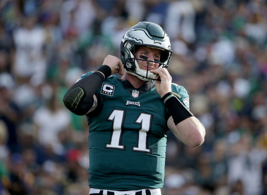 LOS ANGELES, CA - DECEMBER 10: Quarterback Carson Wentz #11 of the Philadelphia Eagles adjusts his helmet after being hit against the Los Angeles Rams during the second quarter at Los Angeles Memorial Coliseum on December 10, 2017 in Los Angeles, California. The Eagles defeated the Rams 43-35.
