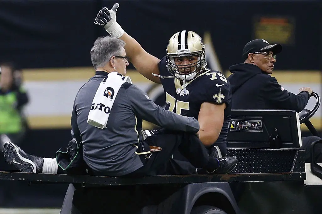 NEW ORLEANS, LA - JANUARY 07: Andrus Peat #75 of the New Orleans Saints is carted of the field during the first half of the NFC Wild Card playoff game against the Carolina Panthers at the Mercedes-Benz Superdome on January 7, 2018 in New Orleans, Louisiana.
