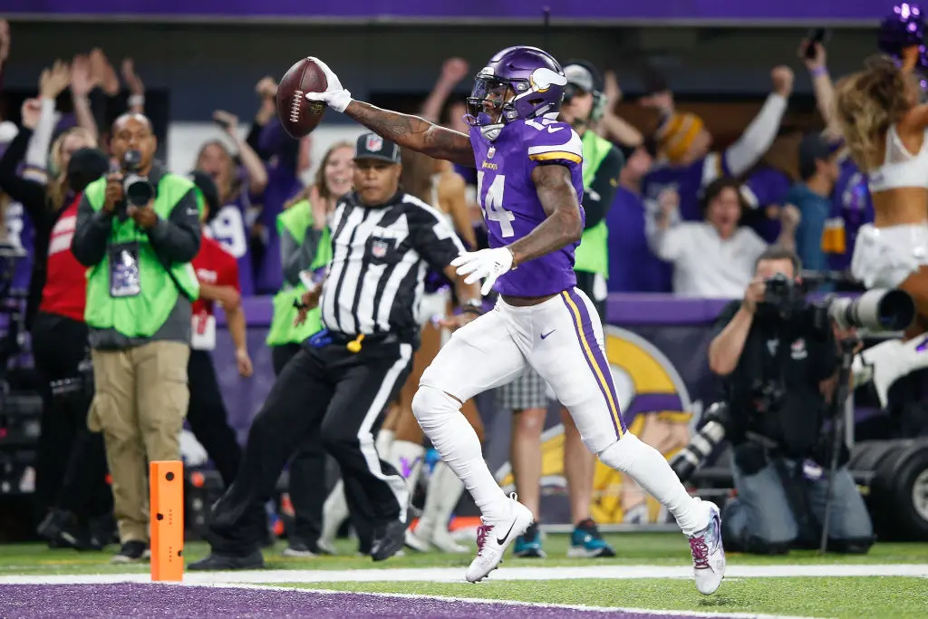 MINNEAPOLIS, MN - JANUARY 14: Stefon Diggs #14 of the Minnesota Vikings scores a touchdown as time expires against the New Orleans Saints during the second half of the NFC Divisional Playoff game at U.S. Bank Stadium on January 14, 2018 in Minneapolis, Minnesota.