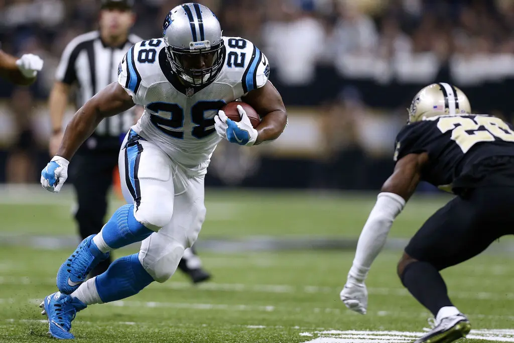 NEW ORLEANS, LA - JANUARY 07: Jonathan Stewart #28 of the Carolina Panthers runs with the ball as Ken Crawley #20 of the New Orleans Saints defends during the first half of the NFC Wild Card playoff game at the Mercedes-Benz Superdome on January 7, 2018 in New Orleans, Louisiana.