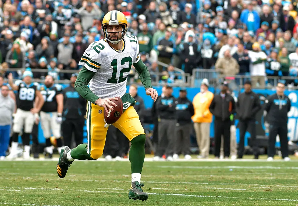 CHARLOTTE, NC - DECEMBER 17: Aaron Rodgers #12 of the Green Bay Packers runs with the ball against the Carolina Panthers in the second quarter during their game at Bank of America Stadium on December 17, 2017 in Charlotte, North Carolina.