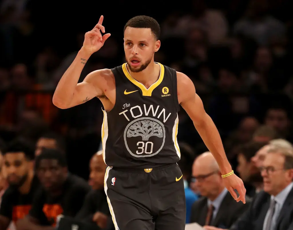 Stephen Curry #30 of the Golden State Warriors celebrates his three point shot in the second half against the New York Knicks at Madison Square Garden on February 26, 2018 in New York City
