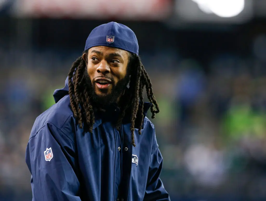 SEATTLE, WA - DECEMBER 03: Injured cornerback Richard Sherman of the Seattle Seahawks smiles from the sidelines before the game against the Philadelphia Eagles at CenturyLink Field on December 3, 2017 in Seattle, Washington.