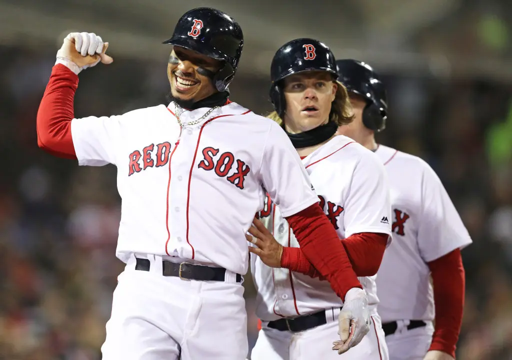 BOSTON, MA - APRIL 10: Mookie Betts #50 of the Boston Red Sox celebrates with Brock Holt #12 after hitting a grand slam during the sixth inning against the New York Yankees at Fenway Park on April 10, 2018 in Boston, Massachusetts. 