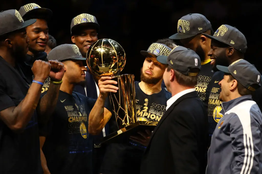 CLEVELAND, OH - JUNE 08: Stephen Curry #30 of the Golden State Warriors celebrates with the Larry O'Brien Trophy after defeating the Cleveland Cavaliers during Game Four of the 2018 NBA Finals at Quicken Loans Arena on June 8, 2018 in Cleveland, Ohio. The Warriors defeated the Cavaliers 108-85 to win the 2018 NBA Finals