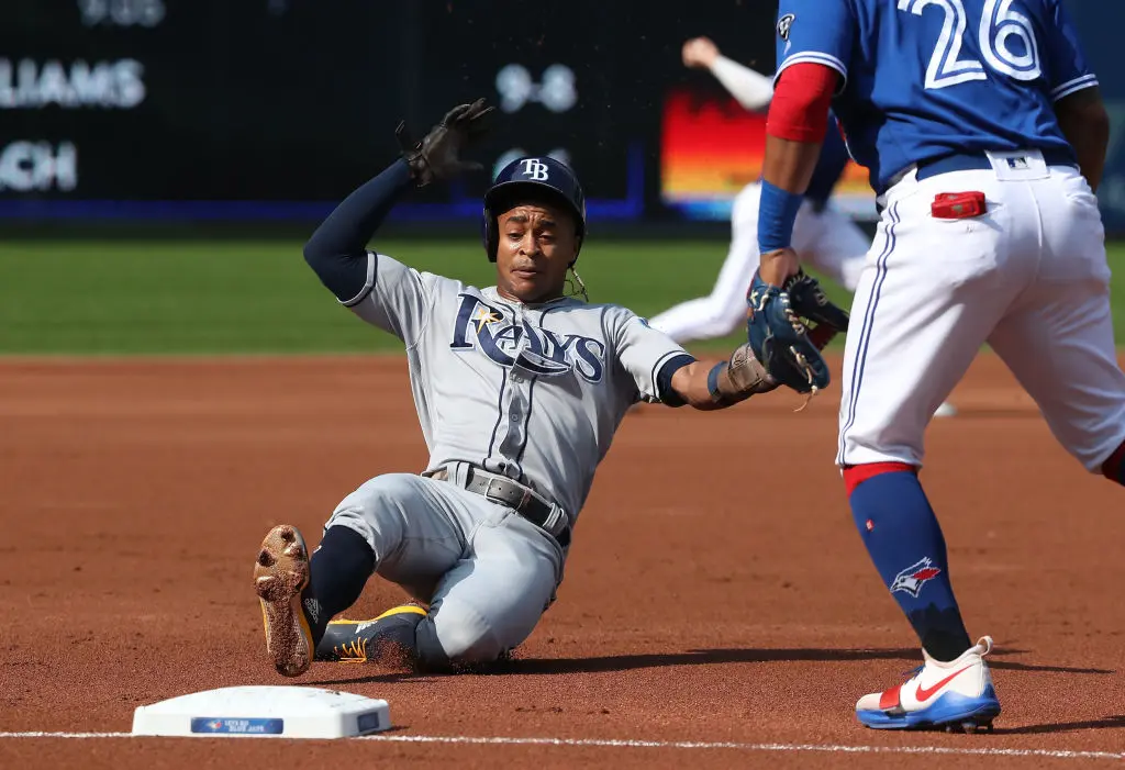 TORONTO, ON - AUGUST 11: Mallex Smith #0 of the Tampa Bay Rays slides into third base safely as he advances from second base on a groundout before scoring a run in the first inning during MLB game action against the Toronto Blue Jays at Rogers Centre on August 11, 2018 in Toronto, Canada