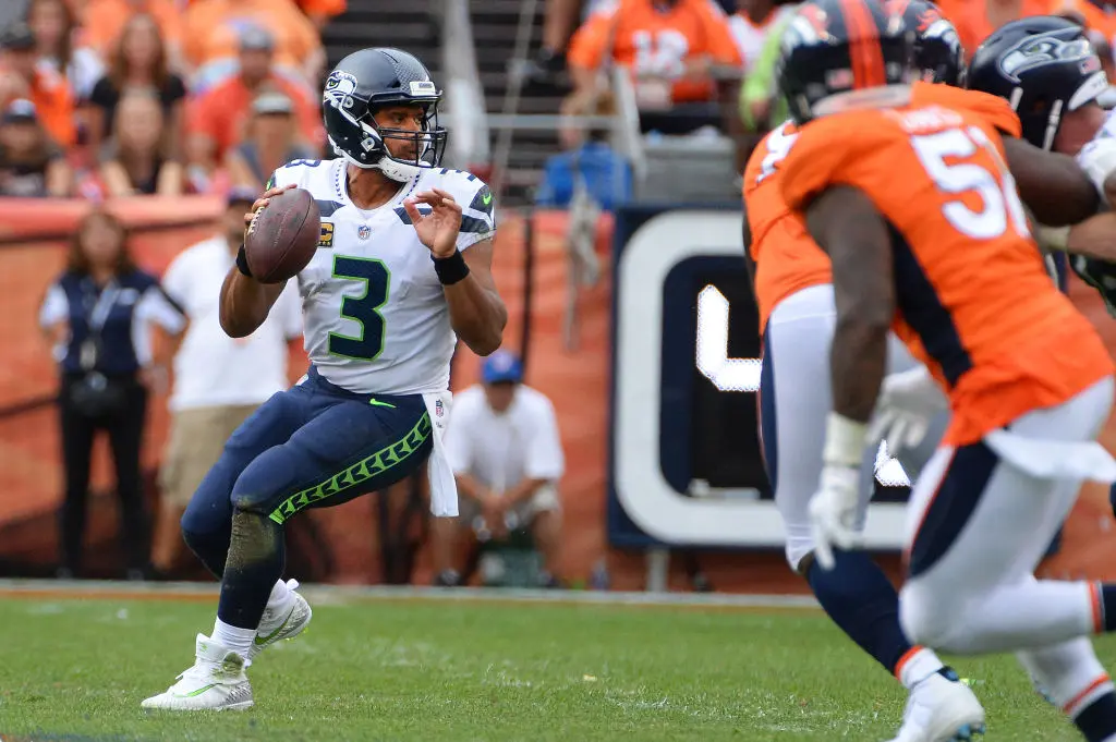 DENVER, CO - SEPTEMBER 9: Quarterback Russell Wilson #3 of the Seattle Seahawks drops back for a pass against the Seattle Seahawks at Broncos Stadium at Mile High