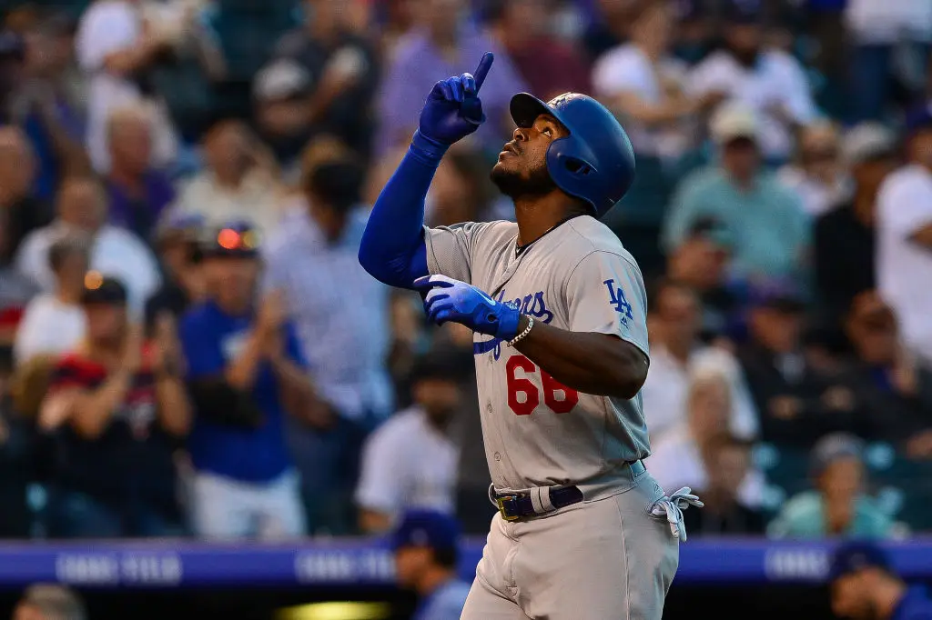 Yasiel Puig #66 of the Los Angeles Dodgers celebrates on the base path after hitting a second inning solo homerun against the Colorado Rockies at Coors Field on September 7, 2018 in Denver, Colorado.