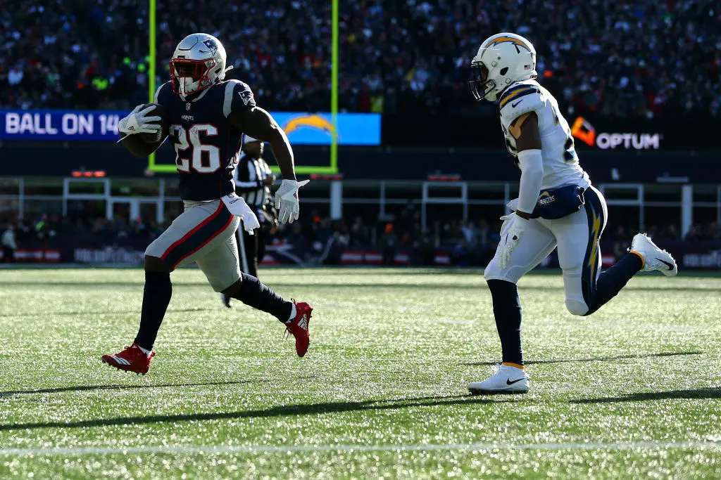 FOXBOROUGH, MASSACHUSETTS - JANUARY 13: Sony Michel #26 of the New England Patriots carries the ball during the first quarter in the AFC Divisional Playoff Game against the Los Angeles Chargers at Gillette Stadium on January 13, 2019 in Foxborough, Massachusetts