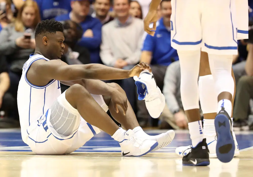 DURHAM, NORTH CAROLINA - FEBRUARY 20: Zion Williamson #1 of the Duke Blue Devils reacts after falling as his shoe breaks during their game against the North Carolina Tar Heels at Cameron Indoor Stadium on February 20, 2019 in Durham, North Carolina