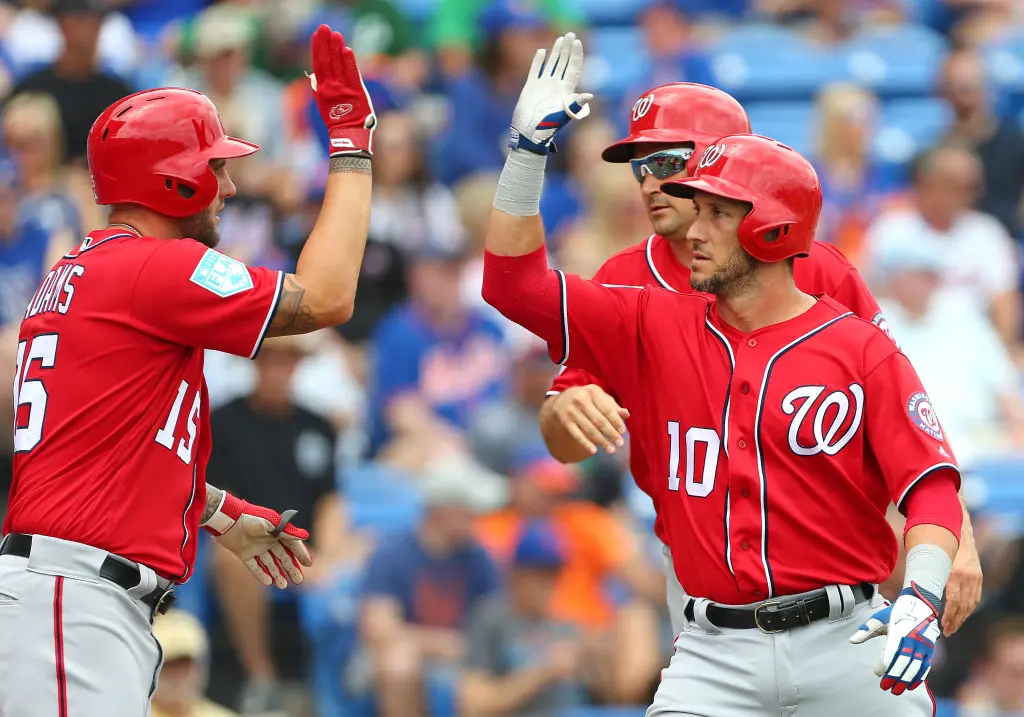PORT ST. LUCIE, FL - MARCH 15: Yan Gomes #10 of the Washington Nationals celebrates his home run with Matt Adams #15 and Ryan Zimmerman #11 against the New York Mets during a spring training baseball game at First Data Field on March 15, 2019 in Port St. Lucie, Florida. The Nationals defeated the Mets 11-3
