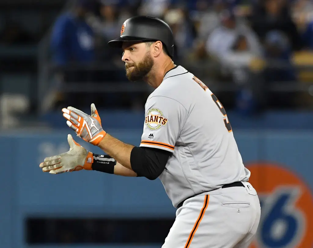 LOS ANGELES, CA - APRIL 01: Brandon Belt #9 of the San Francisco Giants claps his hands as he stands on second base after hitting a two RBI double in the seventh inning of the game against the Los Angeles Dodgers at Dodger Stadium on April 1, 2019 in Los Angeles, California