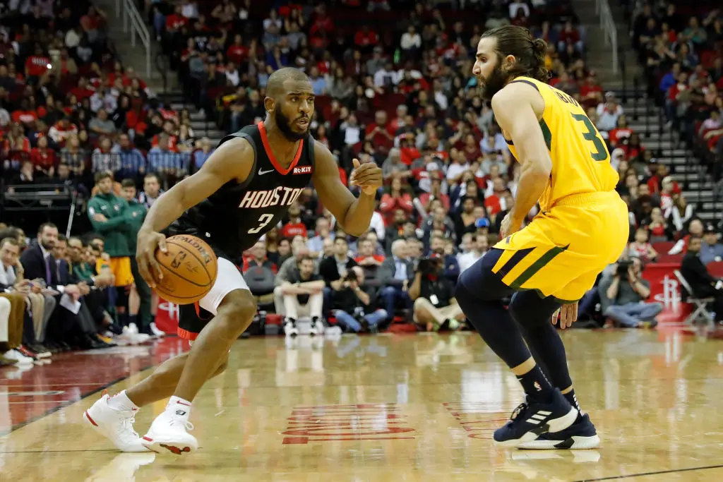 HOUSTON, TX - DECEMBER 17: Chris Paul #3 of the Houston Rockets drives to the basket defended by Ricky Rubio #3 of the Utah Jazz in the second half at Toyota Center on December 17, 2018 in Houston, Texas